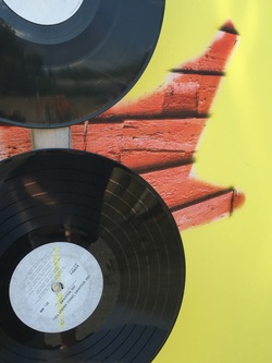 Record albums on yellow and red background